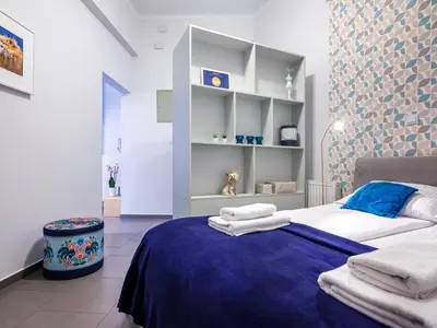 a bedroom with a bed with towels on it at CracWoW Apartment in Kraków