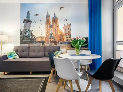 a living room with a couch and a table at CracWoW Apartment in Kraków