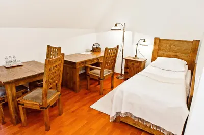 a bedroom with a table and a bed and a desk at Zamek Królewski w Niepołomicach in Niepołomice