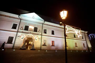 a building with a street light in front of it at night at Zamek Królewski w Niepołomicach in Niepołomice