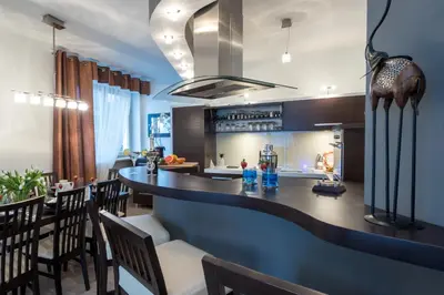 a kitchen and dining room with a bar and chairs at Prywatna Rezydencja Marylin Monroe Rabka in Rabka