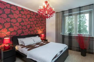 a bedroom with a large bed and a red wall at Prywatna Rezydencja Marylin Monroe Rabka in Rabka