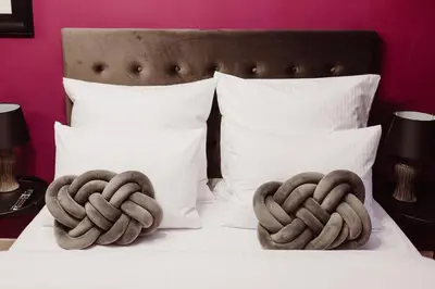 two towels are on top of a bed at Kings City - Blich Apartment in Kraków