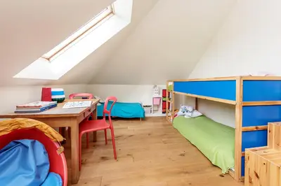 a room with a table and a bunk bed at Dom w Grodzisku in Skała