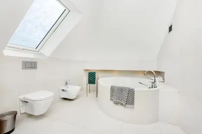 a bathroom with a tub and a toilet and a window at Dom w Grodzisku in Skała