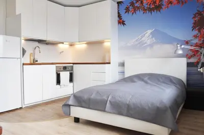 a bedroom with a bed and a mountain in the background at Os. 2 pułku 26 - studio by Homeprime in Kraków