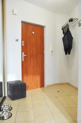 a room with a door and an umbrella on the wall at Os. 2 pułku 26 - studio by Homeprime in Kraków