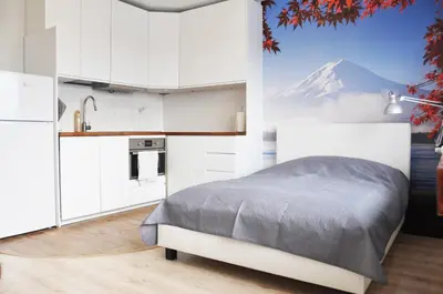 a bedroom with a bed and a mountain in the background at Os. 2 pułku 26 - studio by Homeprime in Kraków