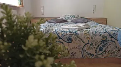 a bed with two pillows and a blanket on it at Lukas Guest Rooms in Kraków