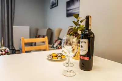 a bottle of wine and a glass on a table at Nowe Zabłocie in Kraków