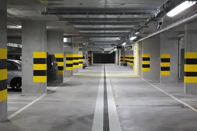an empty parking garage with yellow and black stripes at Nowe Zabłocie in Kraków