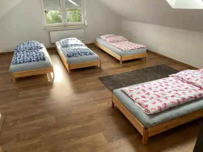 three beds in a room with wooden floors at Domki, apartament, pokój, Limanowa in Limanowa