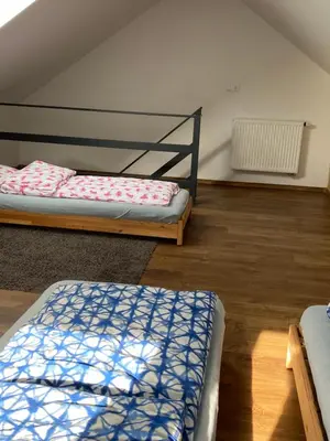 a room with two beds in a room with a attic at Domki, apartament, pokój, Limanowa in Limanowa