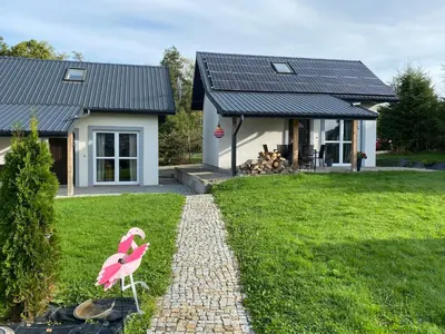 a fake pink flamingo in front of a house at Domki, apartament, pokój, Limanowa in Limanowa