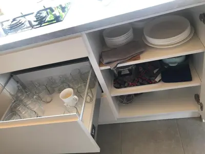 a kitchen cabinet filled with plates and dishes at Domki, apartament, pokój, Limanowa in Limanowa