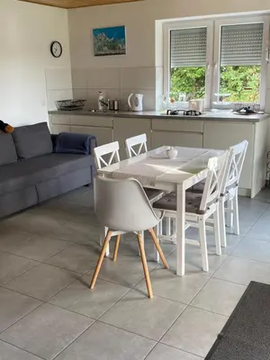a kitchen and dining room with a table and chairs at Domki, apartament, pokój, Limanowa in Limanowa