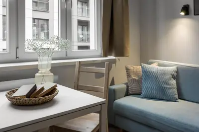 a living room with a couch and a table at Solna Atelier in Kraków