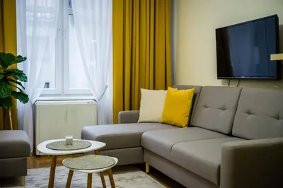 a living room with a couch and a tv at Apartament Wietora WAWELOFTS in Kraków