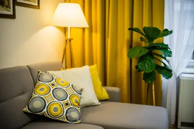 a living room with a couch and a pillow at Apartament Wietora WAWELOFTS in Kraków