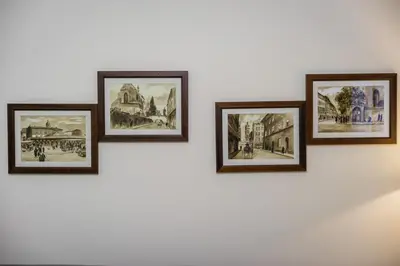a group of drawings on a white wall at Apartament Wietora WAWELOFTS in Kraków