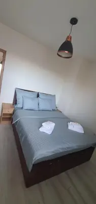 a bedroom with a bed with two towels on it at PIANISSIMO in Kraków