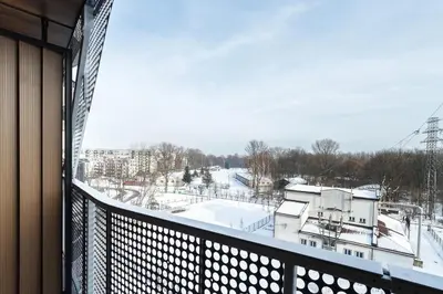 a balcony with a view of a snow covered yard at PIANISSIMO in Kraków