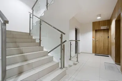 a hallway with stairs and a wooden door at PIANISSIMO in Kraków