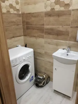 a small bathroom with a washing machine and a sink at PIANISSIMO in Kraków