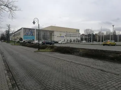 a building with cars parked on the side of a road at Salt Mine Apartment 64m2 in Wieliczka