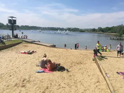 a group of people on the beach at a lake at Salt Mine Apartment 64m2 in Wieliczka