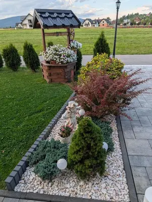 a garden with a gazebo and some plants at Apartament Przy Potoku in Zubrzyca Górna