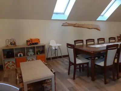 a dining room with a table and chairs and skylights at Apartament Przy Potoku in Zubrzyca Górna