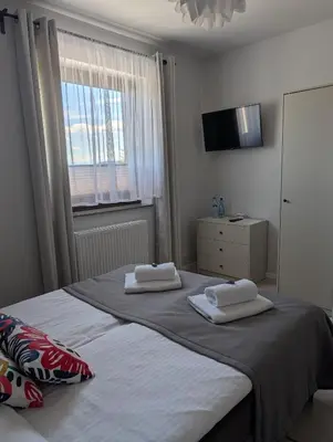 a bedroom with a bed with two towels on it at Apartament Przy Potoku in Zubrzyca Górna