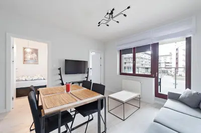 a living room with a table and a couch at Ludwinowska11 Apartments in Kraków