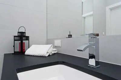 a bathroom with a sink and a faucet at Ludwinowska11 Apartments in Kraków