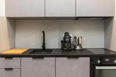 a kitchen with a sink and a coffee maker on a counter at Ludwinowska11 Apartments in Kraków