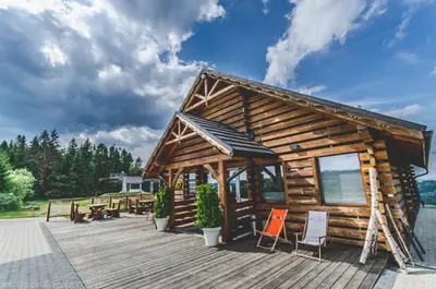 a conservatory with tables and chairs and windows at Hotel Kompleks Beskid z basenem i stokiem narciarskim - blisko Babiej Góry in Spytkowice