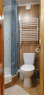 a bathroom with a toilet and a glass shower at Willa Szarotka in Rabka