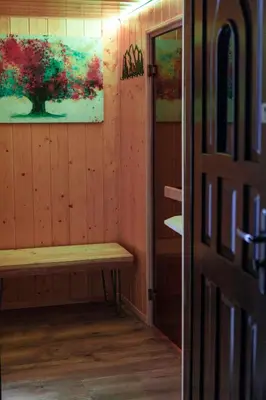 a room with a bench and a painting on the wall at Willa Szarotka in Rabka