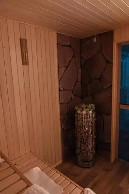 a corner of a sauna with a stone wall at Willa Szarotka in Rabka