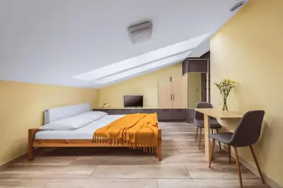 a bedroom with a bed and a table and chairs at Native Apartments Rakowicka 6 in Kraków