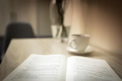 an open book on a table with a cup of coffee at Native Apartments Rakowicka 6 in Kraków