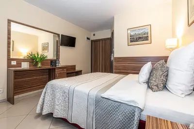 a bedroom with a bed and a large mirror at Hotel Soray in Wieliczka