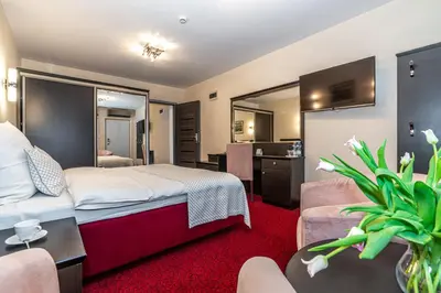 a room with a desk with a phone and a chair at Hotel Soray in Wieliczka
