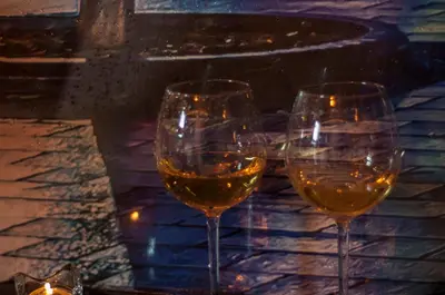 three glasses of white wine sitting on a table at UNDERGROUND Jacuzzi Rooms in Kraków