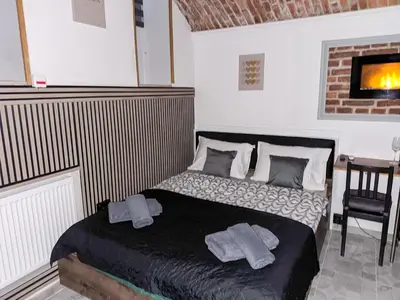 a bedroom with a bed with two towels on it at UNDERGROUND Jacuzzi Rooms in Kraków