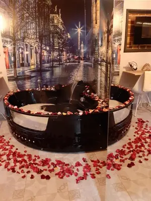 a large fountain with red rose petals on the ground at UNDERGROUND Jacuzzi Rooms in Kraków