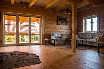 a living room with a couch and chairs and windows at Wrzosowe Zacisze in Siepraw