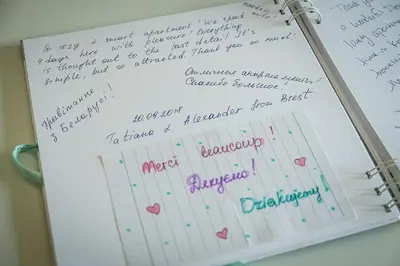 a notebook with handwriting on it with a pen at Apartament Turkusowy - Kraków, Kazimierz in Kraków