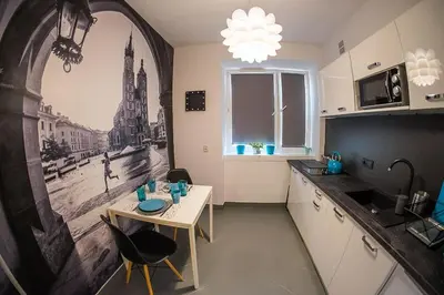 a kitchen with a small table in a kitchen at Apartament Turkusowy - Kraków, Kazimierz in Kraków